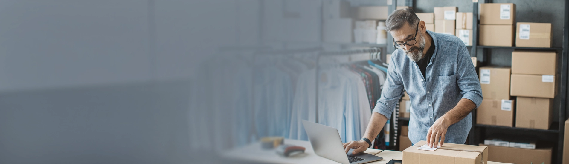 A man placing a label on a retail shipping box