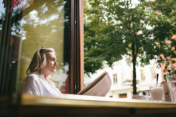 Older woman reading a newspaper