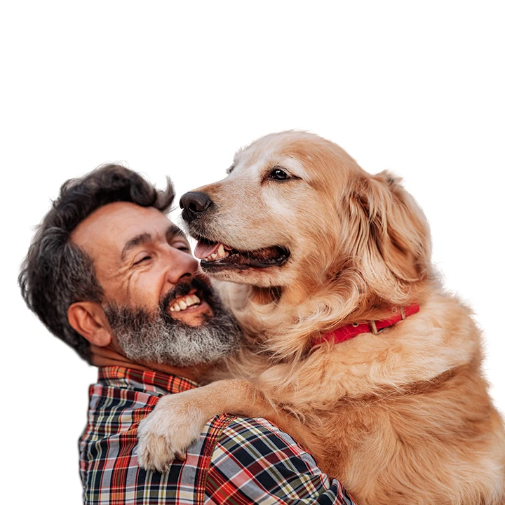 man smiling while hugging his dog