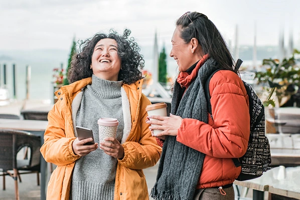 two women chatting over coffee